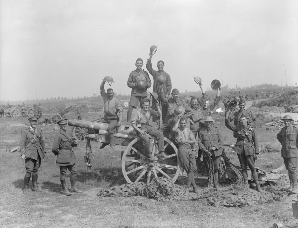 Men of the Royal Garrison Artillery pose happily beside an enemy gun after the capture of Grévillers, 25 August 1918.